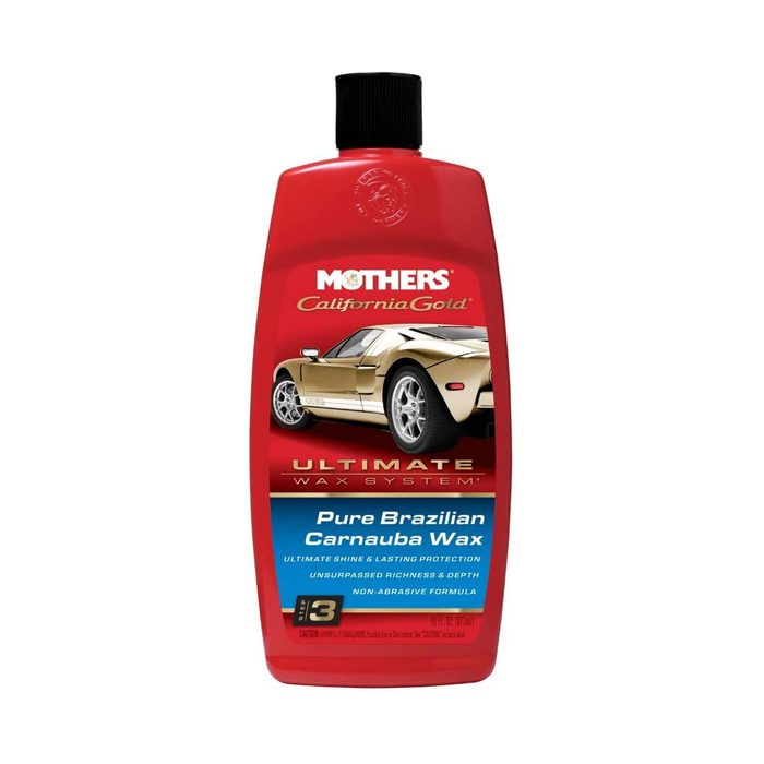 A red bottle of car wax displays a golden sports car label. It promotes enhanced shine and protection for vehicle surfaces.