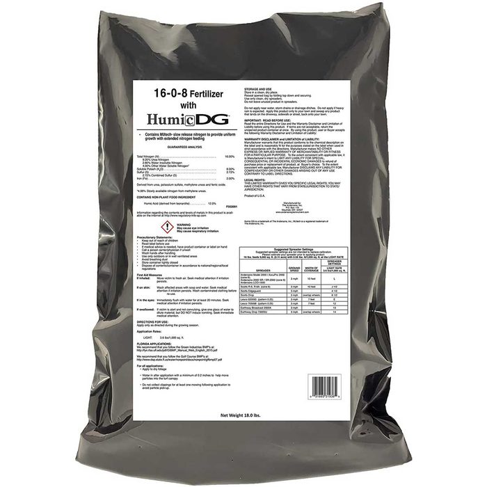A black bag labeled as fertilizer displays usage instructions and nutrient ratios, situated against a neutral background for clear visibility.