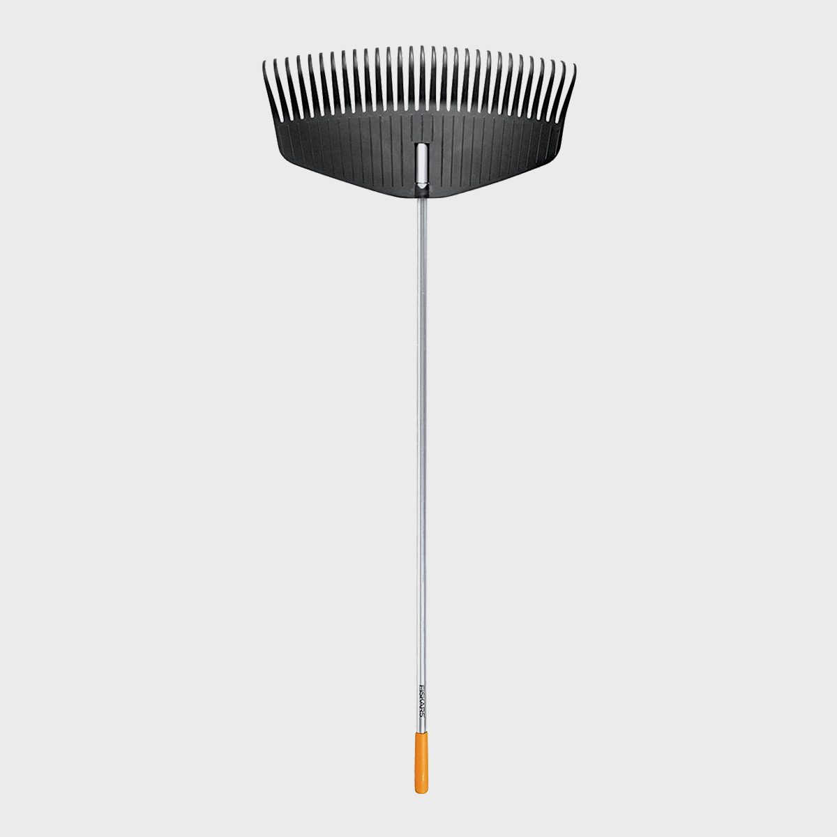 A leaf rake stands upright, its wide, toothed head poised to gather leaves. The lightweight handle extends downward, ready for use in a garden or yard.