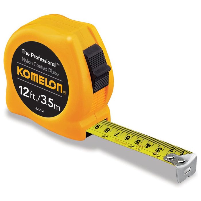 A yellow tape measure extends outward, displaying measurements in feet and meters, typically used in construction or DIY projects to gauge length and dimensions.