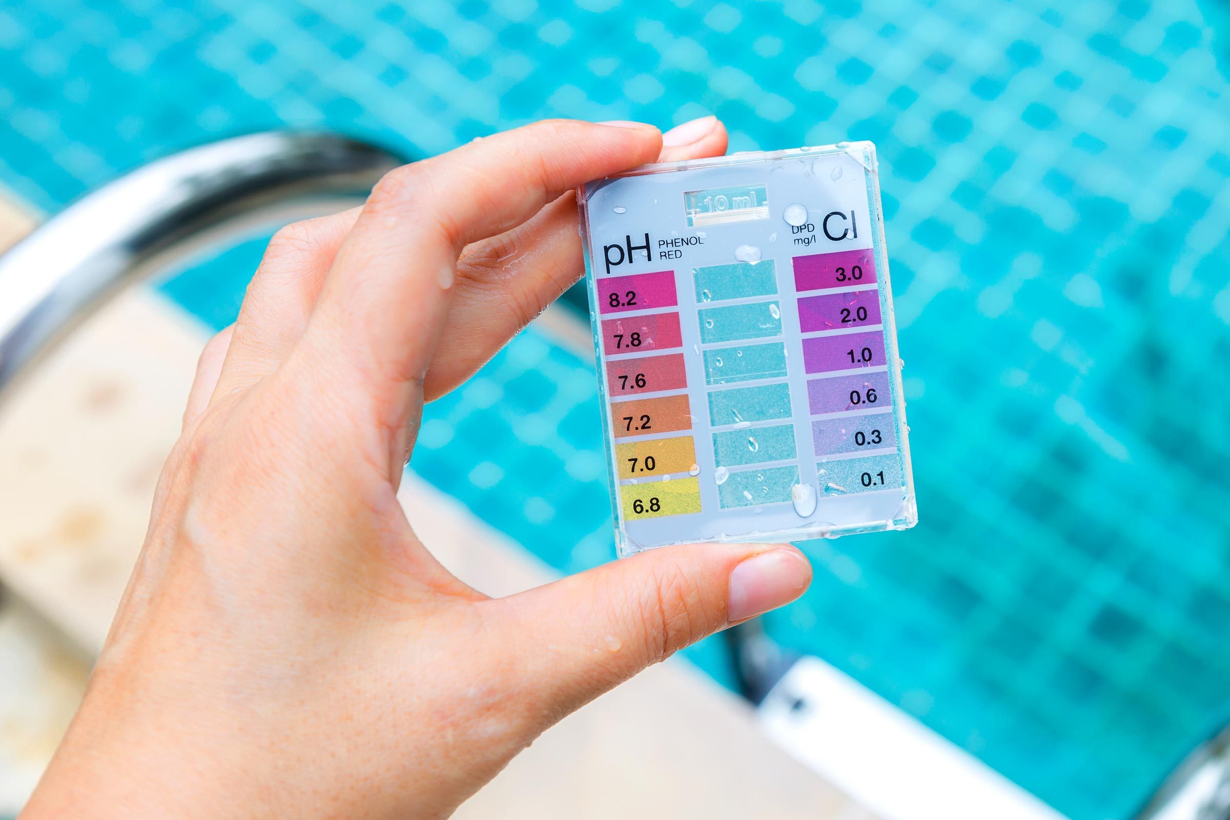 hand with pool PH kit