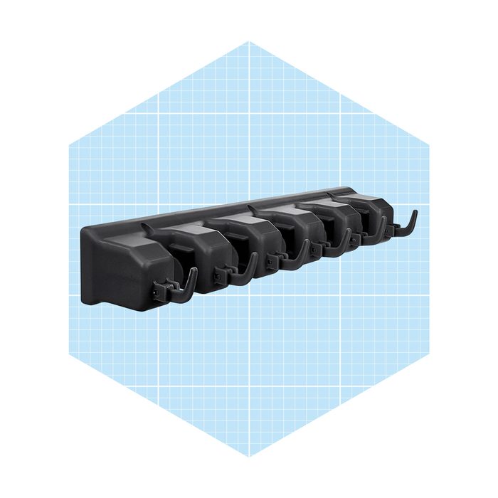 A black wall-mounted hook rack holds multiple hooks, designed for organizing items, set against a light blue grid background.