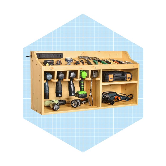 A wooden tool organizer displays various tools, including drills and flashlights, arranged neatly on shelves against a light blue grid background.