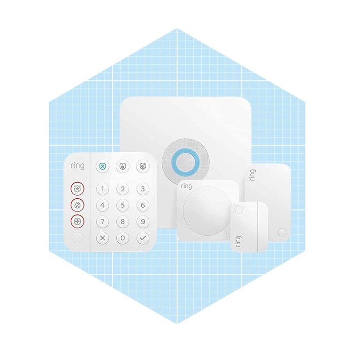 A collection of white security devices, including a keypad, sensor, and hub, is arranged on a light blue grid background, indicating a smart home system.