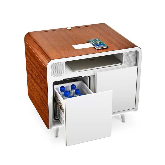 A wooden nightstand holds a smartphone and laptop, while its open drawers reveal bottles of water, blending technology and convenience in a modern setting.