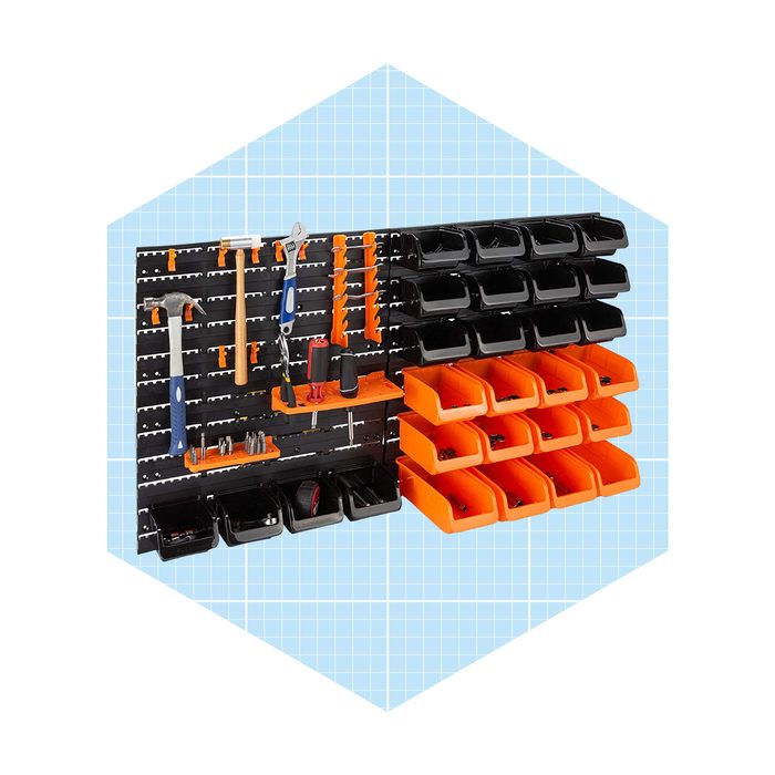 A wall-mounted organization system displays various hand tools and storage bins, effectively arranged against a light blue grid background for easy access and visibility.
