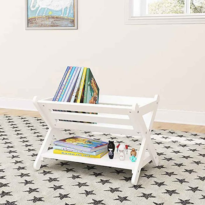 A white book rack holds colorful children