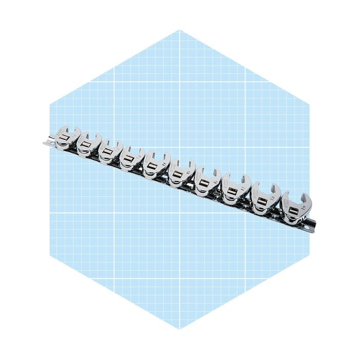 A series of chrome clips align neatly along a metal strip, displayed against a light blue grid background.