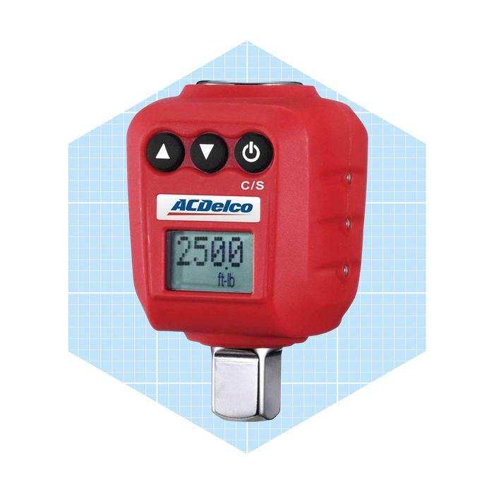 A red digital torque wrench displays 