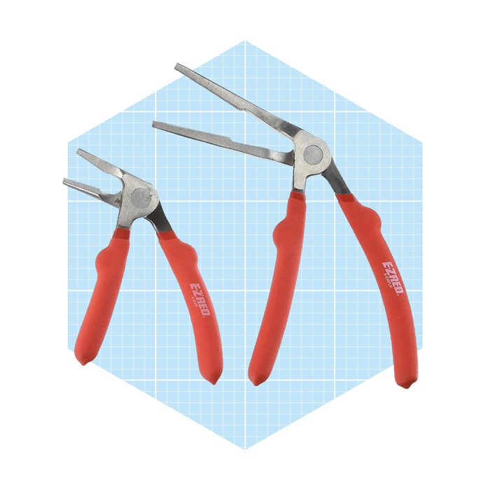 Two pairs of pliers with red rubber grips sit on a light blue grid background, showcasing their metallic jaws designed for gripping and manipulation.