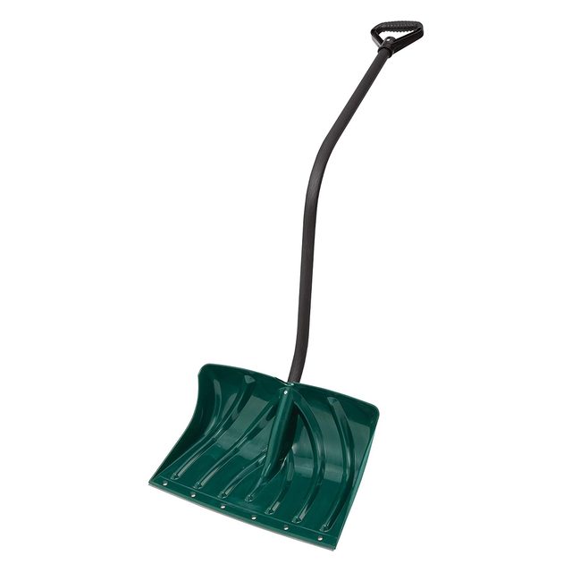A green snow shovel stands upright, featuring a wide, curved blade and a long, black handle, ready for snow removal in a winter environment.