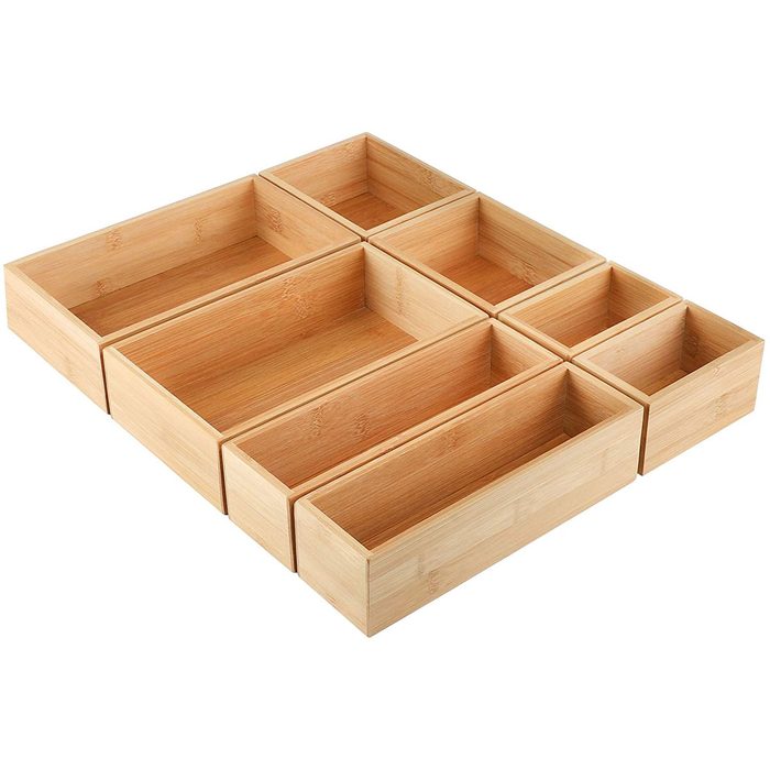 A set of eight bamboo storage boxes arranged in a grid pattern, designed for organizing items neatly on a flat surface.