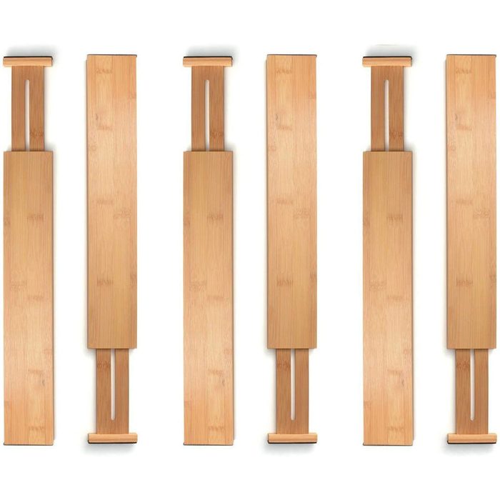 Long bamboo strips are laid flat, showcasing their smooth surfaces and sleek ends, with some featuring connector slots for assembly or adjustment.