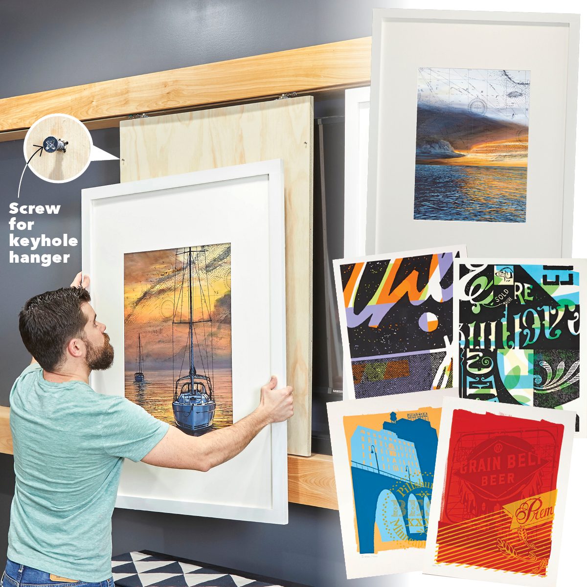 A man is hanging a framed artwork on a wall, surrounded by colorful prints and a wooden shelf in a modern interior space.