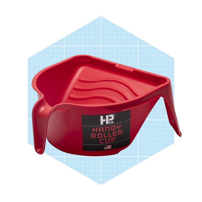 A red triangular paint roller cup rests, designed for easy paint application, set against a light blue grid background.