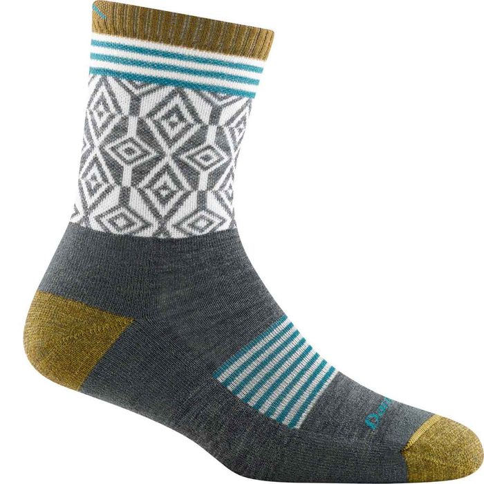 A patterned sock stands upright, showing a mix of geometric designs and colors, set against a plain background.