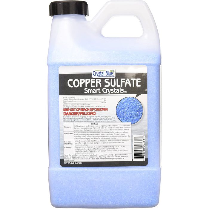 A plastic container of blue crystals labeled 