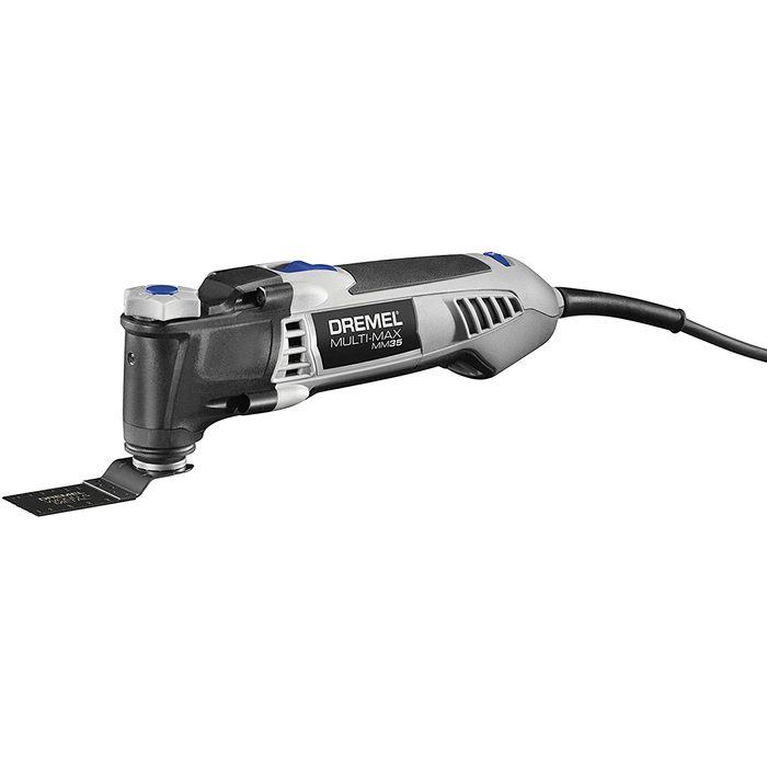 A power tool, the Dremel Multi-Max, features a blade attachment, ready for cutting or sanding, set against a plain white background.