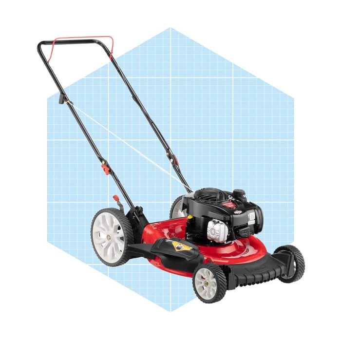 A red lawn mower stands upright, ready for use, with a black engine and white wheels, set against a light blue grid background.