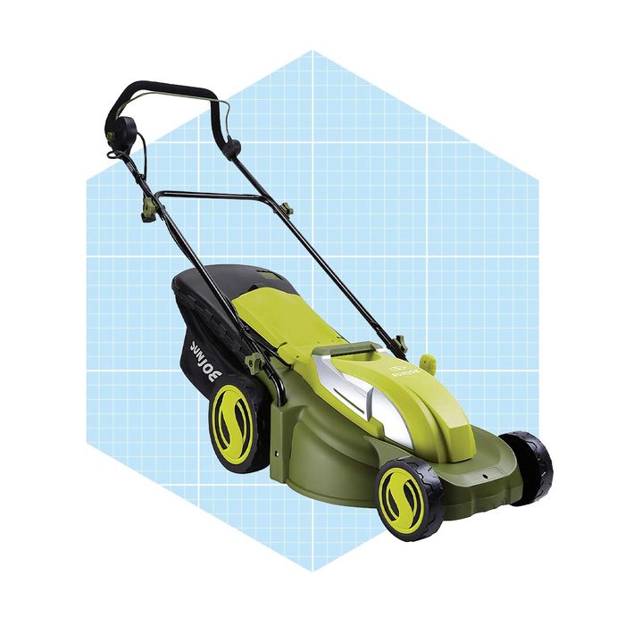 A green electric lawn mower sits upright with its handle extended. It is positioned against a light blue grid background, emphasizing its design.