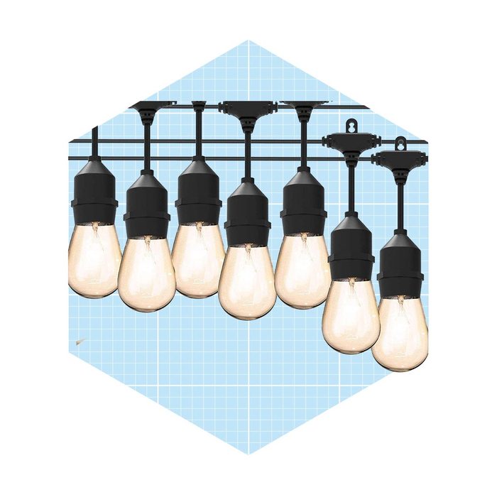 Eight hanging light bulbs illuminate a blue grid background, suspended by black fixtures, creating a modern and stylish lighting arrangement.