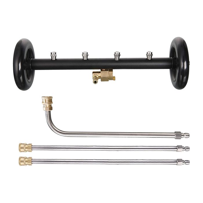 A black, wheeled spray bar has multiple connectors on top, with three metal tubes positioned beneath, designed for distributing liquid in a specific application.