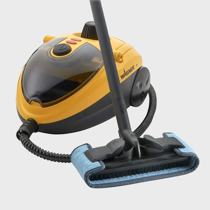 A yellow and black steam cleaner stands still, featuring a handle and a cleaning attachment, designed for deep cleaning surfaces efficiently.