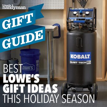 A Kobalt air compressor stands on wheels in a workshop. It features gauges and attached hoses, surrounded by tools and storage containers.