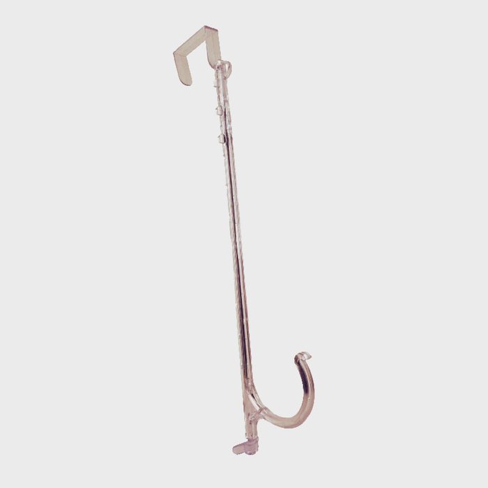 A long, metallic stick with a curved hook at one end is positioned upright against a plain background, suggesting a utility tool for hanging or lifting objects.