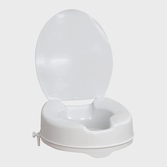 A white portable toilet seat is open, ready for use, positioned against a plain background, indicating a clean and minimalist design for outdoor or emergency needs.