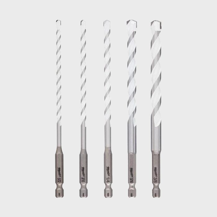 Five metal drill bits of varying lengths stand upright, showcasing their twist designs, against a plain white background.