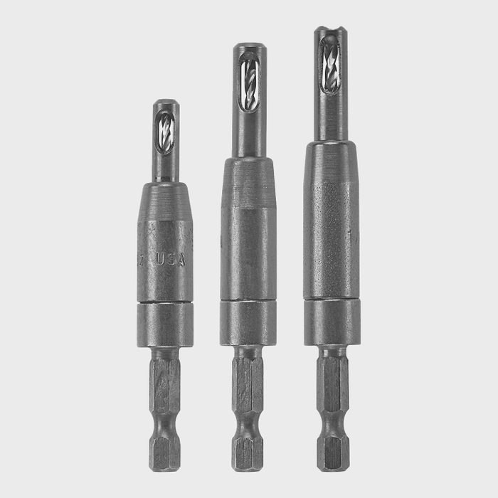 Three metal drill bits of varying lengths are arranged in a row, showing details of their tips and hex shanks against a light background.