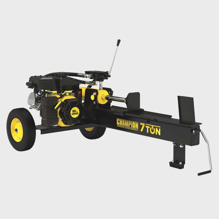 A log splitter, equipped with a gas engine, is positioned on wheels. It processes wood logs, facilitating efficient splitting in outdoor environments.