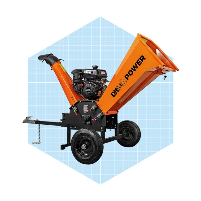 A wood chipper with an orange funnel-like attachment is positioned on wheels, ready to process yard debris in a light blue grid background.