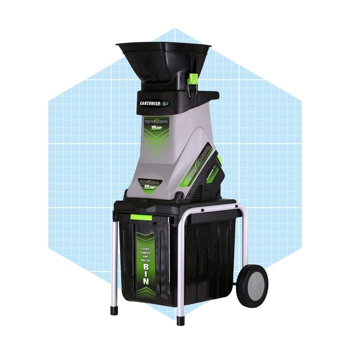 A garden chipper-shredder processes yard waste, mounted on a wheeled frame for mobility, with a collection bin beneath for easy disposal.