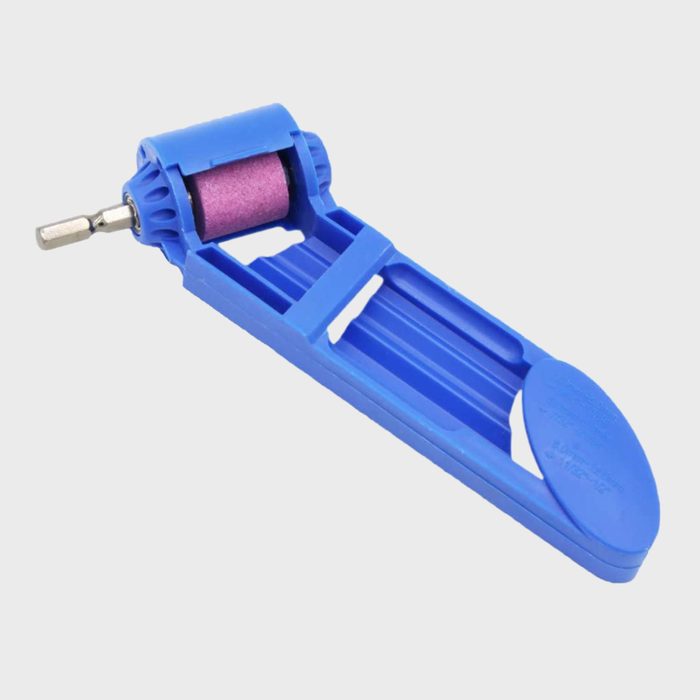 A blue, plastic tool with a roller on one end is positioned horizontally, likely used for applying or smoothing materials in crafting or repair tasks.