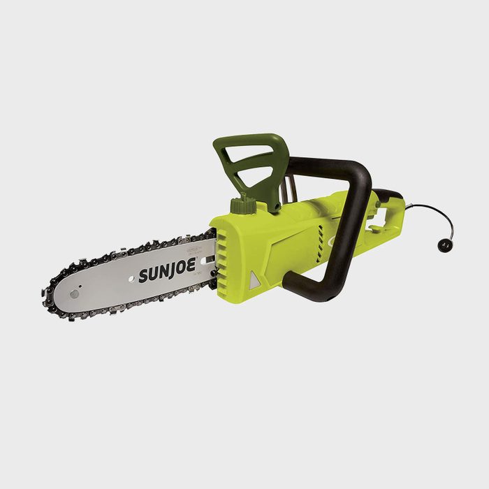 A green electric chainsaw with a metal blade is positioned on a white background, showcasing its handle and safety features, ready for use in cutting tasks.