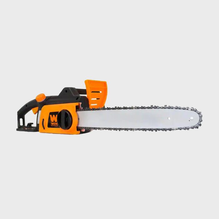 A chainsaw with a black and orange design lies horizontally, featuring a long, silver blade with a chain, resting against a light gray background.