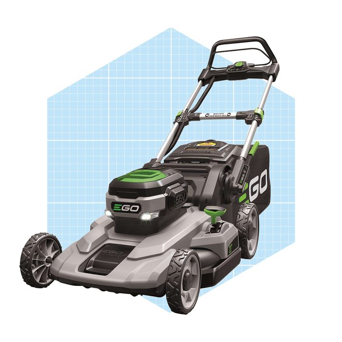 A lawn mower stands ready, featuring a green and gray design with large wheels, illuminated front lights, and a grass collection bag, set against a grid background.