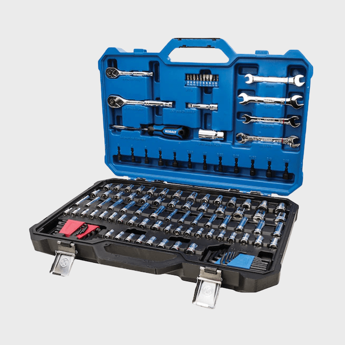 A blue tool set case is open, showcasing numerous sockets, wrenches, and a ratchet, organized for easy access in a workshop or garage setting.