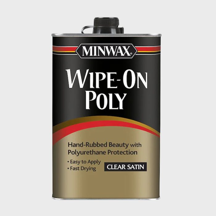 A can of Minwax Wipe-On Poly sits upright, featuring a black and gold design. It indicates easy application and fast-drying polyurethane protection for wood.