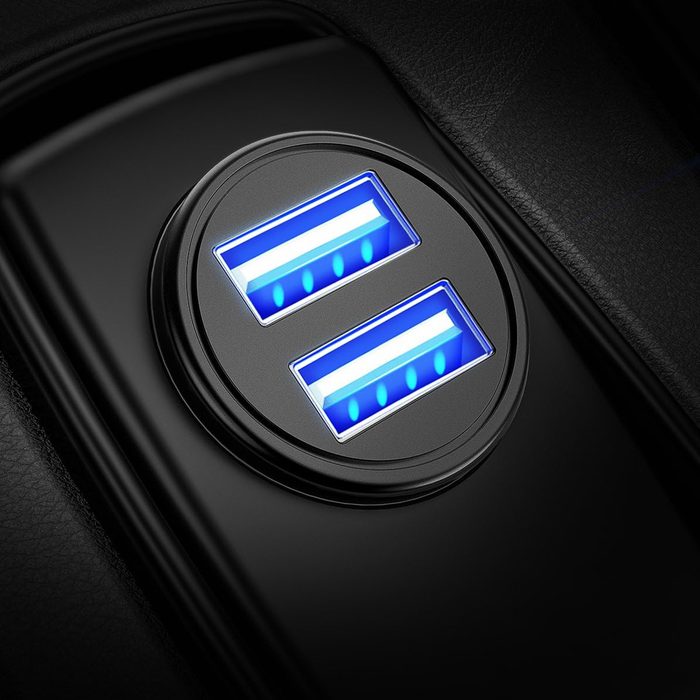 A circular black port with two USB slots is illuminated by blue lights, indicating charging status, set against a textured black background.