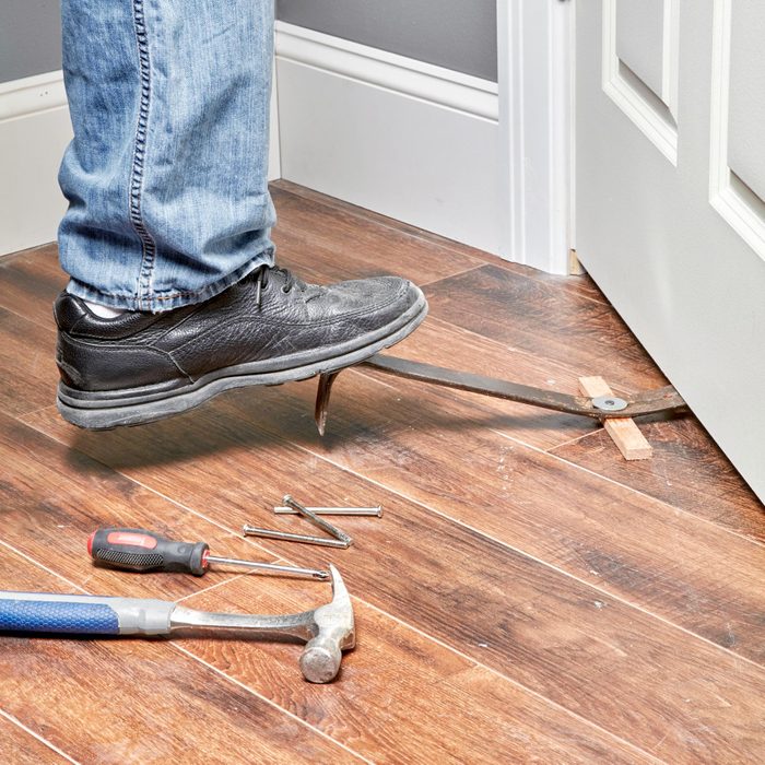 lifting heavy door with a pry bar