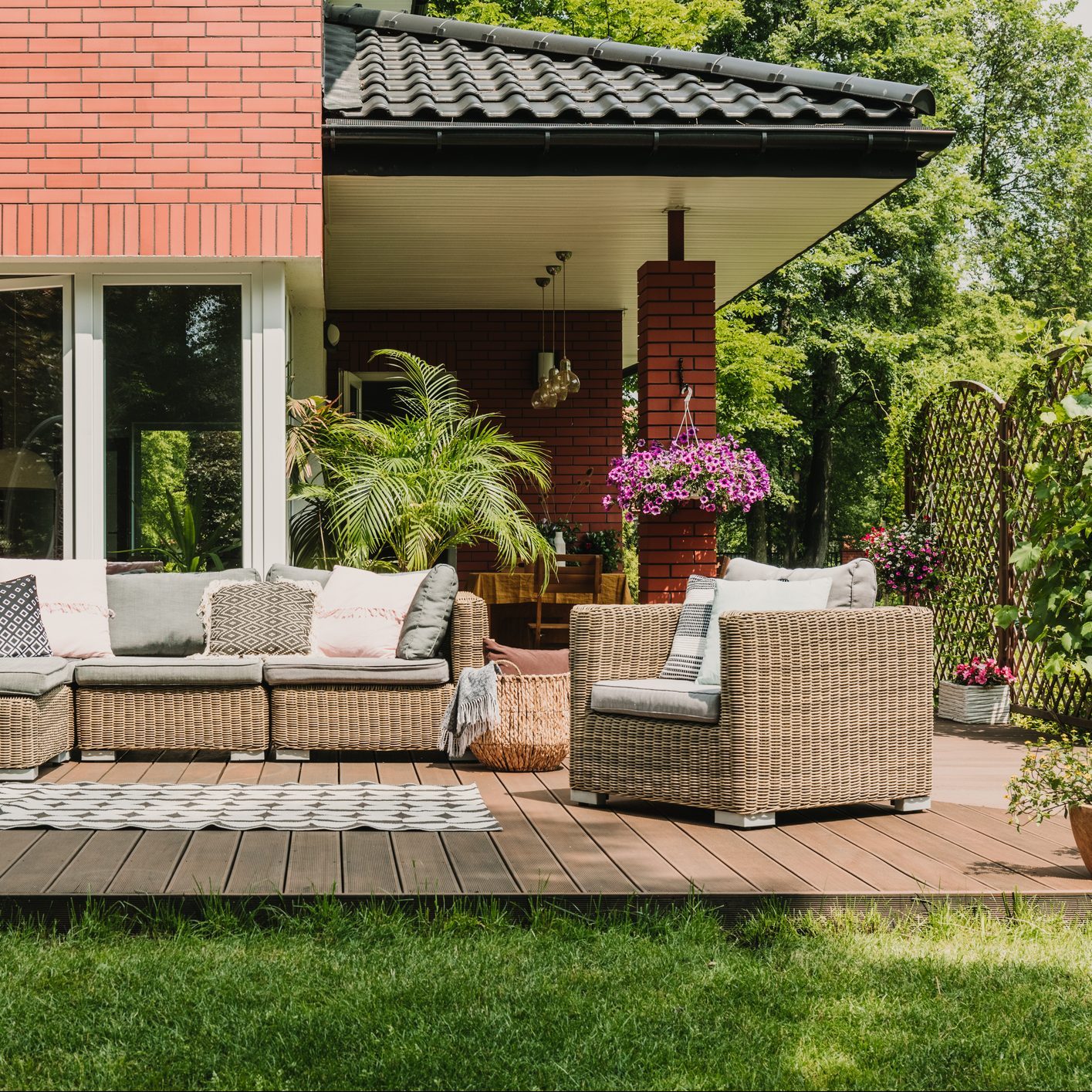 Elegant floating deck with patio furniture in a backyard with green grass