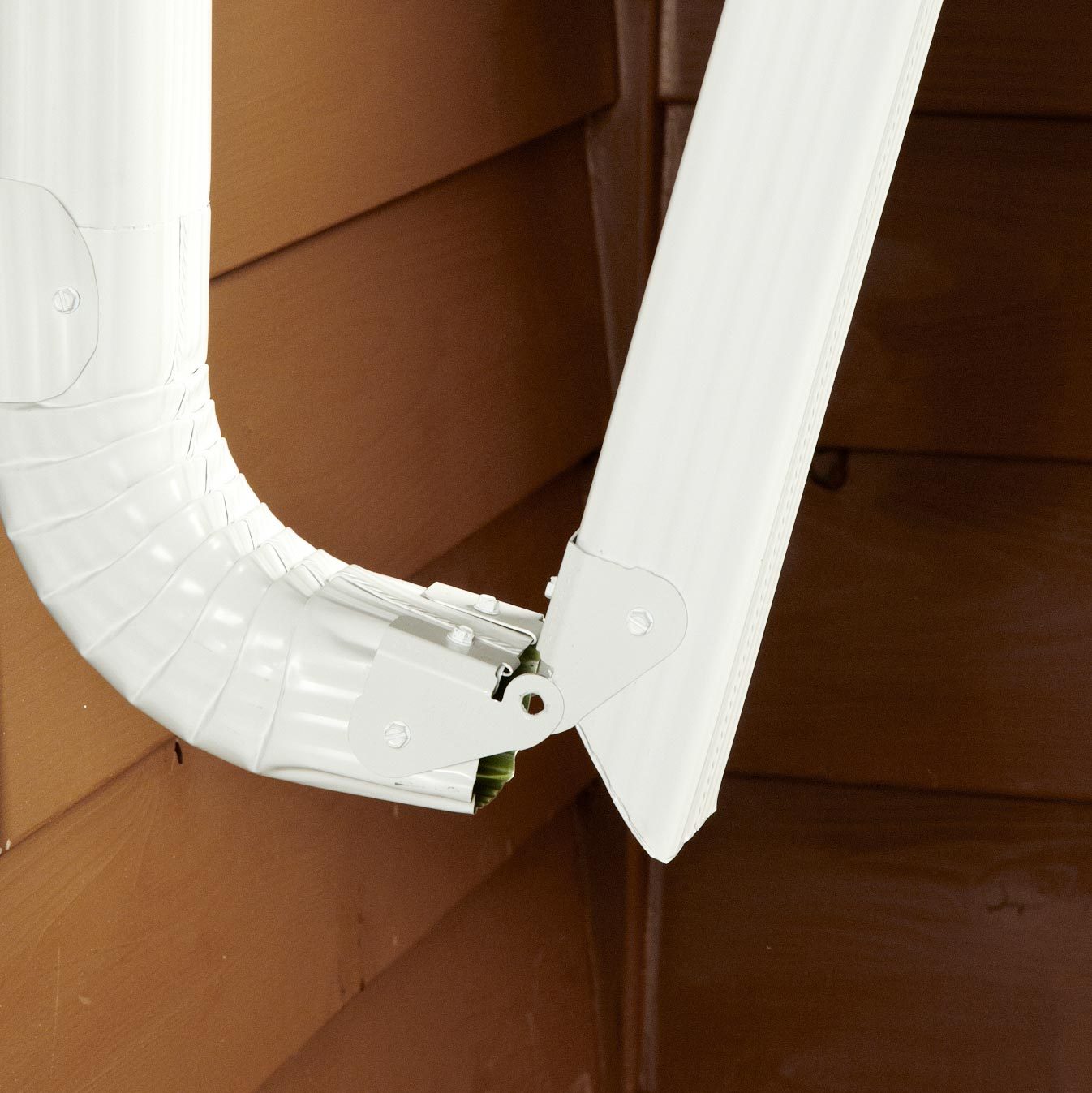close up of a hinge on a gutter downspout
