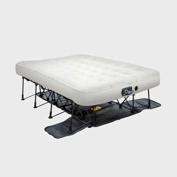 An elevated air mattress is set up on a black frame, designed for sleeping. The background is plain and light-colored.