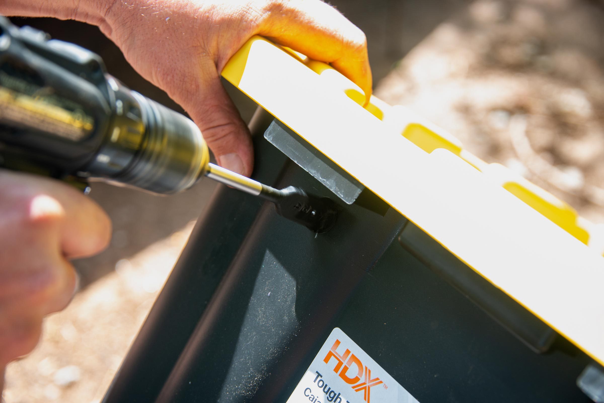 drilling a smaller whole in the side of the plastic tote