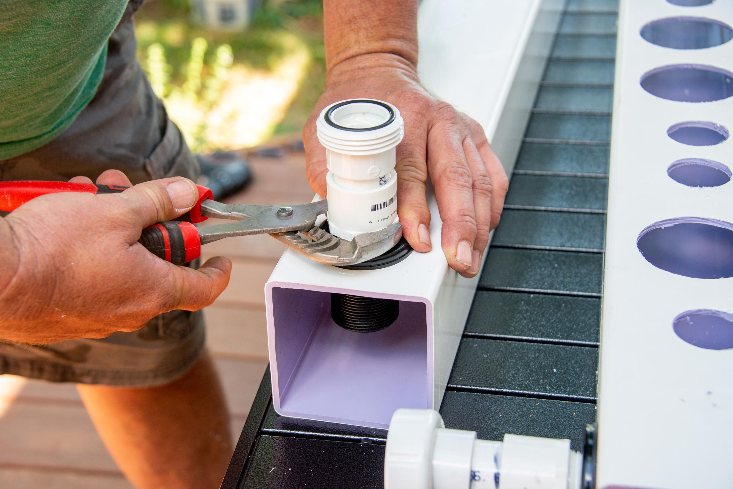 screwing the union fitting into the bulk head at the other end