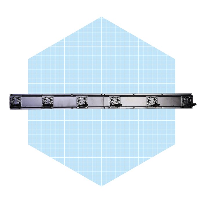 A horizontal black metal rack with multiple hooks is displayed, set against a light blue, grid-patterned background, suggesting a functional storage solution.