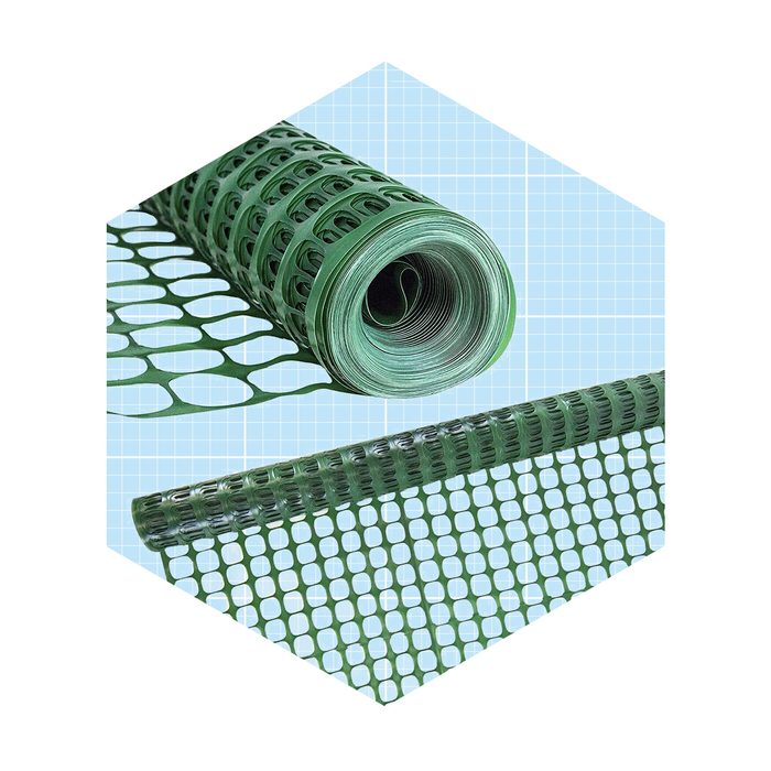 A green plastic mesh roll lies coiled, displaying its perforated pattern, set against a light blue grid background, suggesting a functional design for various applications.